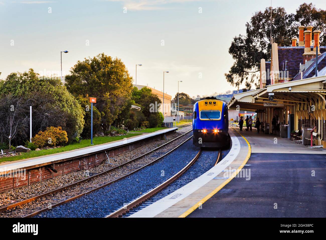 Intercity passenger train arraving at platform of railway station in Bathurst town of rural Australia. Stock Photo