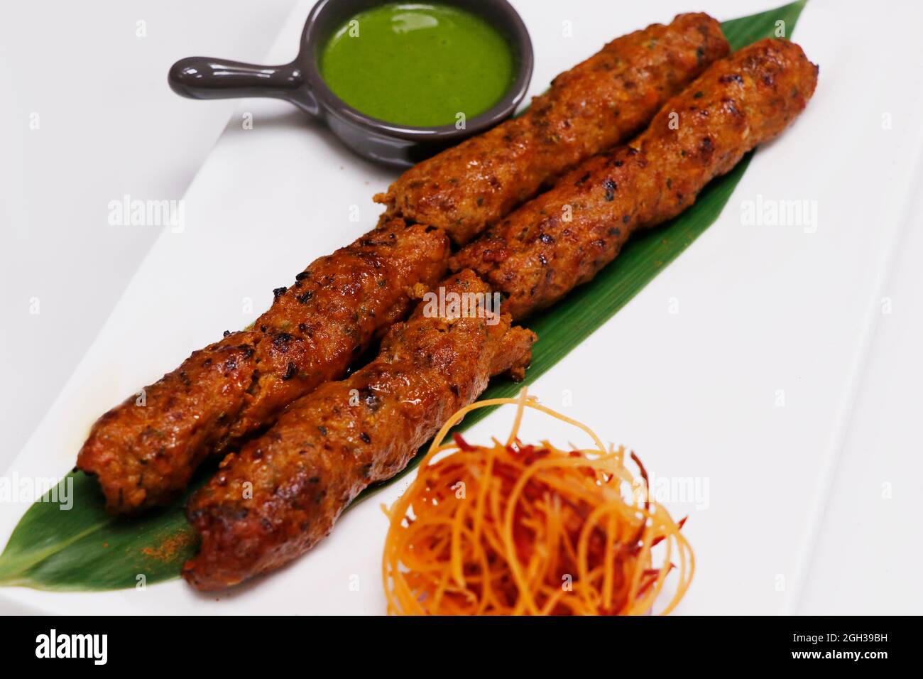 lamb or mutton seekh kebab (mince mutton meat skewer) served with mint chutney, indian street
