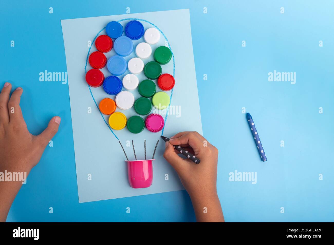 recycling bottle caps craft tutorial, useful ideas for the class, preschool  hour concept Stock Photo - Alamy