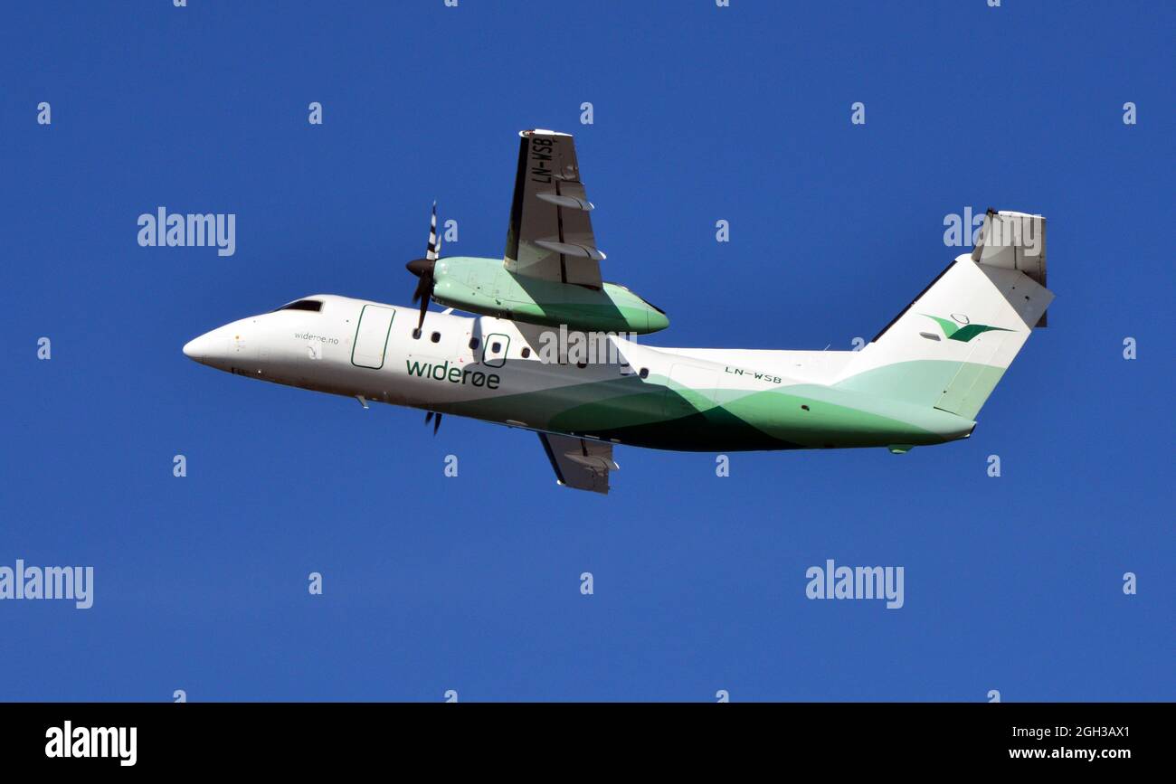 DHC-8 of Wideroe taking off from Alta airport, Finnmark, Norway on a sunny afternoon in June Stock Photo