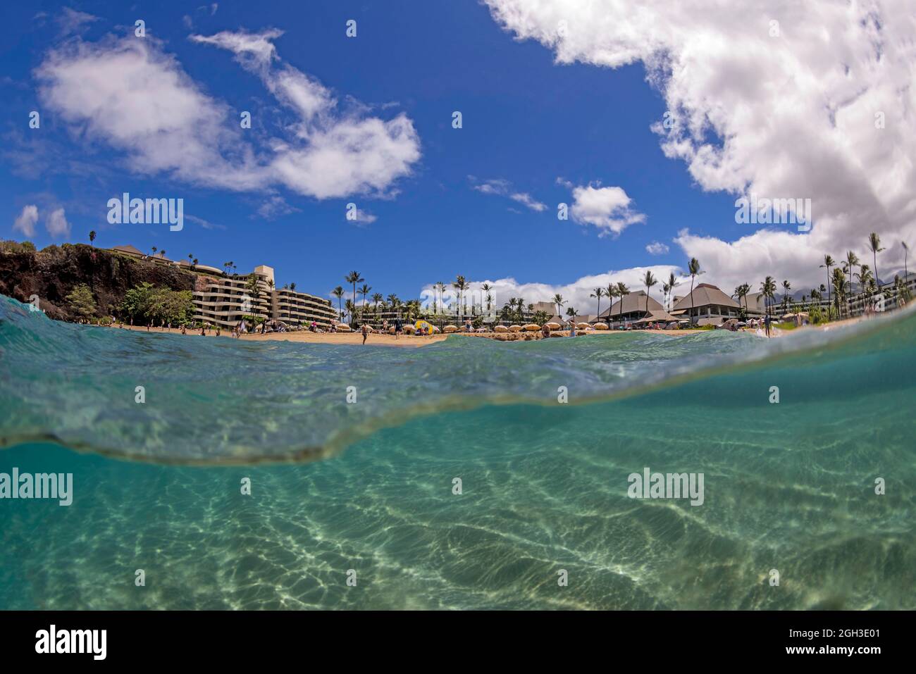 An ocean level split view of the north end of the world famous Ka'anapali Beach and the Sheraton hotel, Maui, Hawaii. Stock Photo