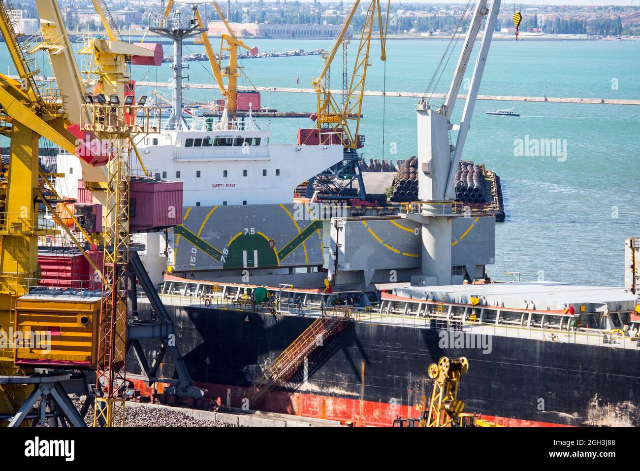 Vessel dry cargo on loading by iron ore, unloading in port. Bulker in ...