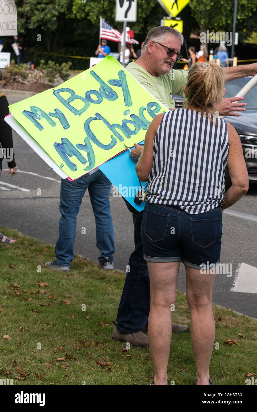 Olympia, USA. 4 Sep, 2021. Mid-day a person holding a My Body My Choice sign during the End The Mandates rally at the Olympia State Capital. Protestors are calling for Governor Jay Inslee to cancel his newly enacted mask mandate. Washington state mask mandates were recently reinstated after a surge in Delta Variant infections became the dominate Covid-19 strain in Washington state. Credit: James Anderson/Alamy Live News Stock Photo