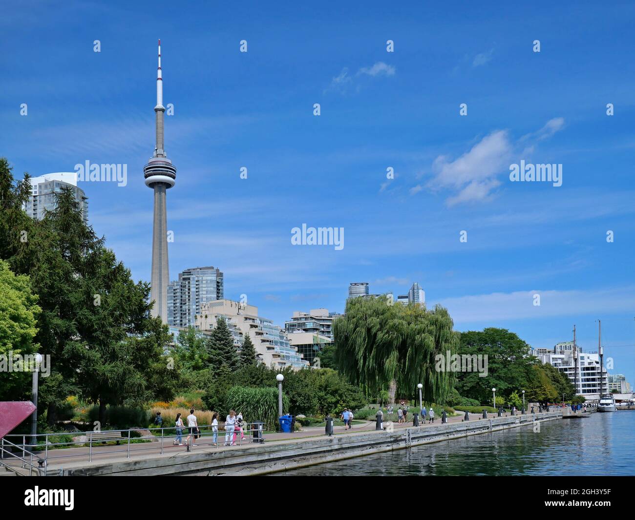 Toronto, Canada - September 3, 2021:  Lake Ontario waterfront promenade with high rise apartment buildings in the background Stock Photo
