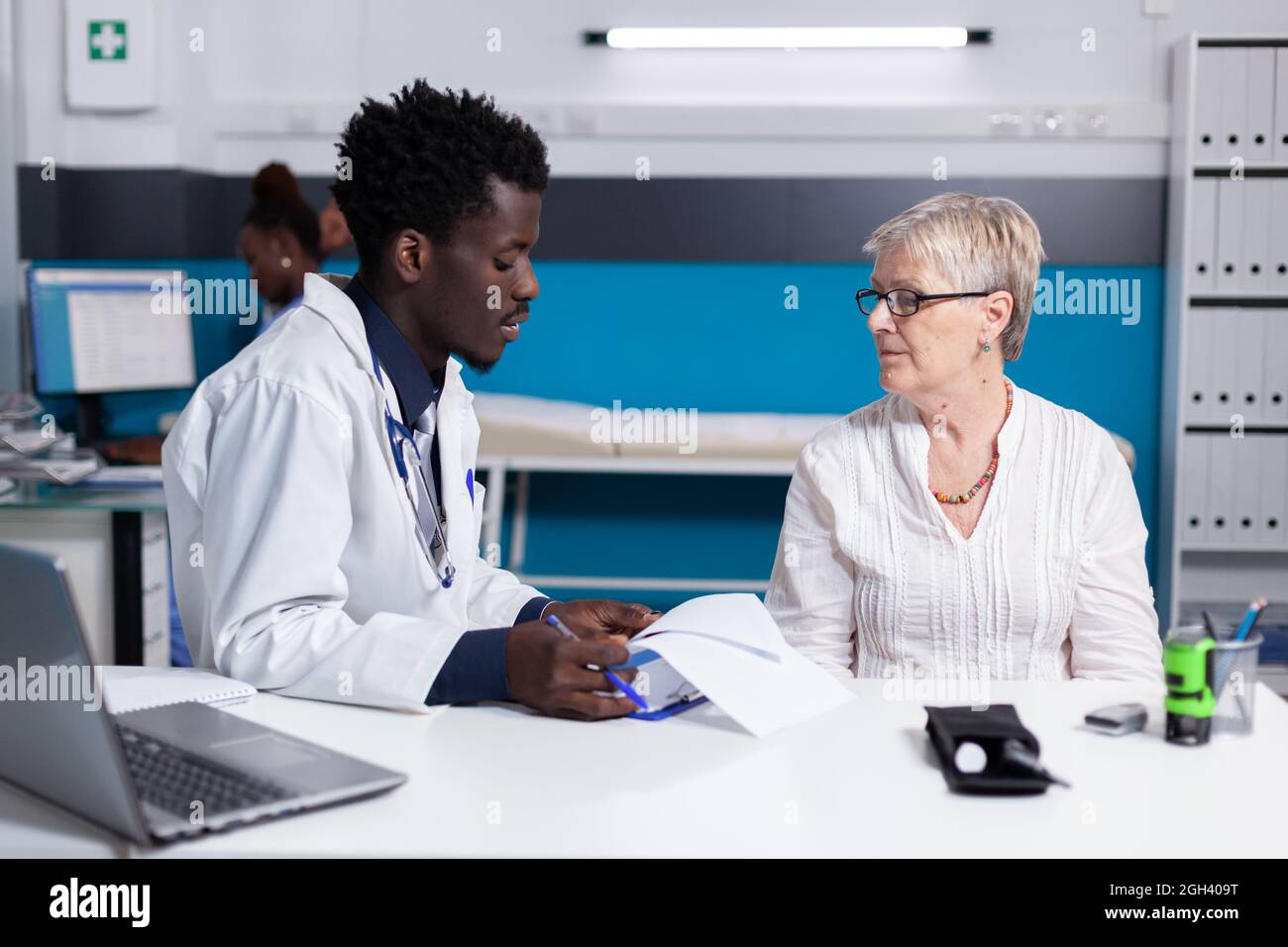 Black man with doctor profession talking to elder patient with disease ...