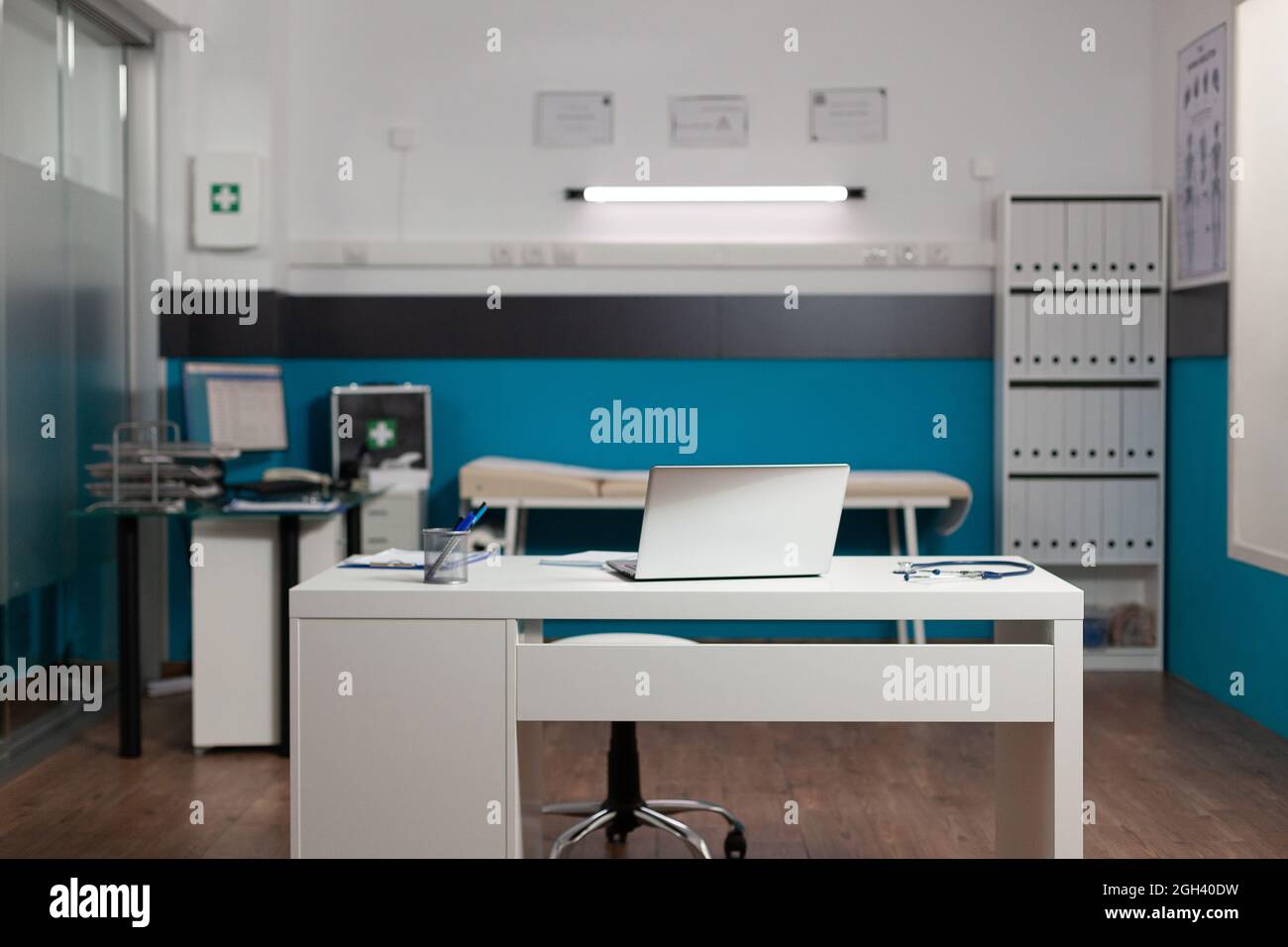 Empty doctors workplace room with desk and technology for 