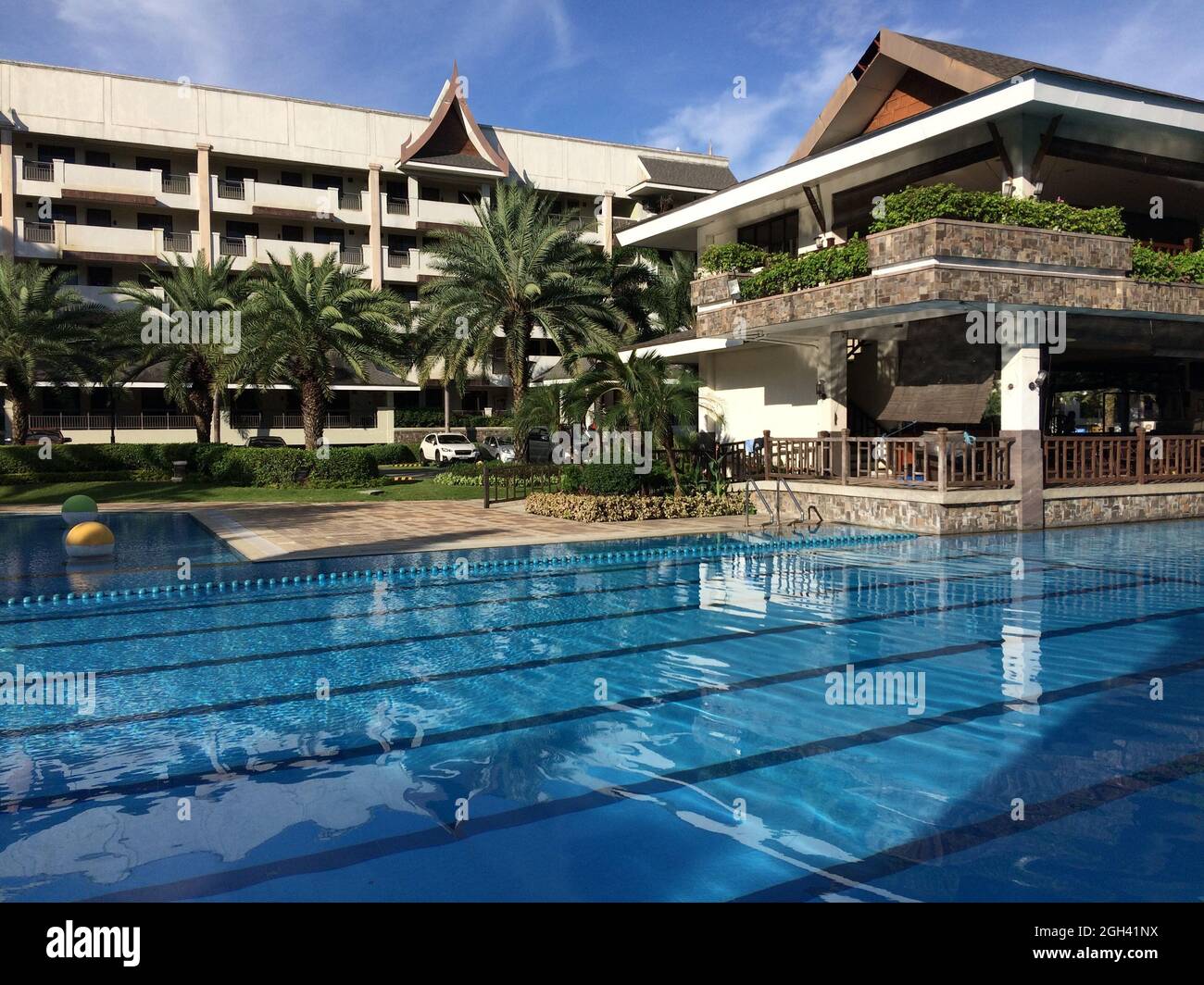 MANIL, PHILIPPINES - Dec 11, 2020: A closeup shot of a swimming pool and thai style building in Mani in Philippines Stock Photo