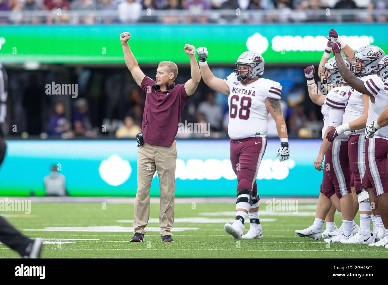 Montana Grizzlies head coach Bobby Hauck signals to bring his team if just before the end of the third quarter of an NCAA college football game agains Stock Photo