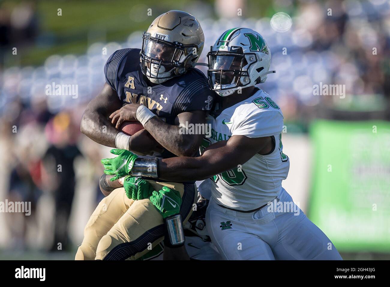 September 4, 2021: Navy Midshipmen fullback James Harris II (37) runs the ball and brought down by a host of Marshall Thundering Herd including Marshall Thundering Herd defensive lineman Elijah Alston (58) during the regular season opening game between the Marshall Thundering Herd and the Navy Midshipmen at Navy-Marine Corps Memorial Stadium in Annapolis, Maryland Photographer: Cory Royster Stock Photo