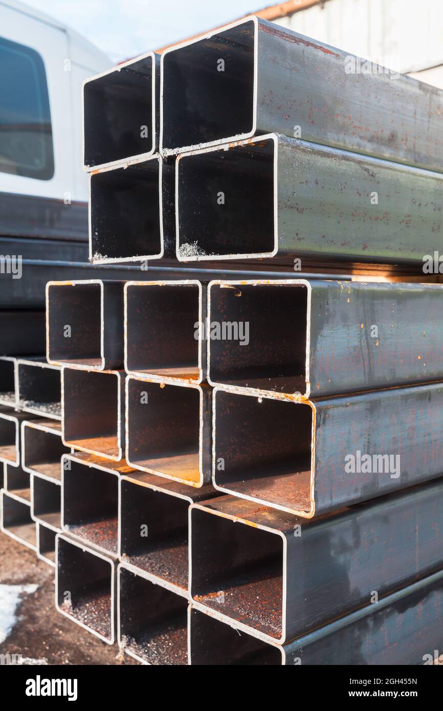 Stack of rolled metal products, steel pipes of rectangular cross-section Stock Photo