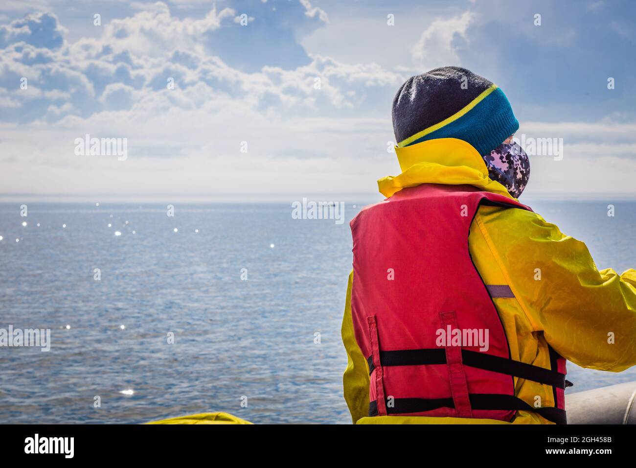 Passenger of an inflatable boat with their life jacket on whale