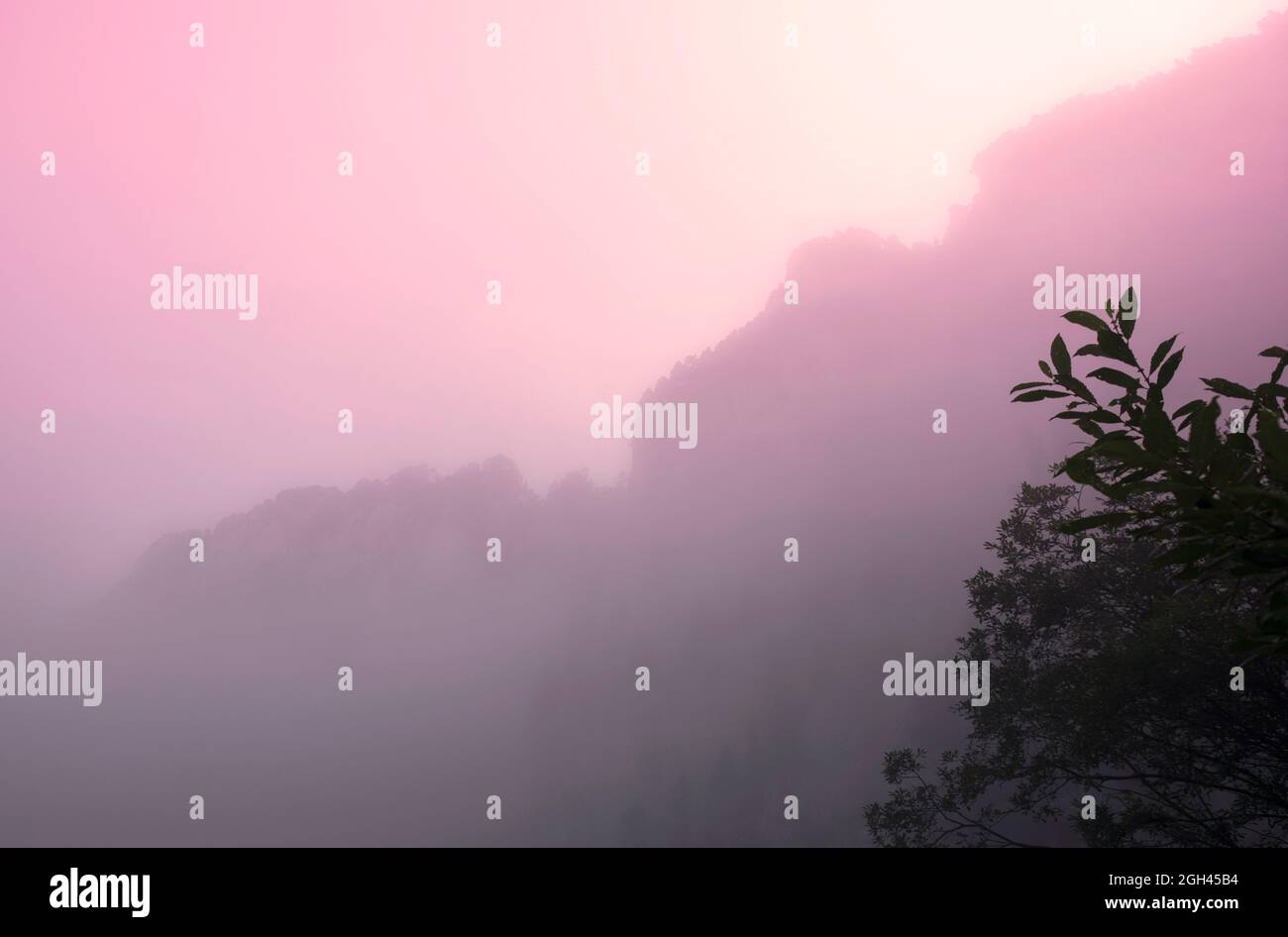 Sun through the clouds in the mountains Stock Photo