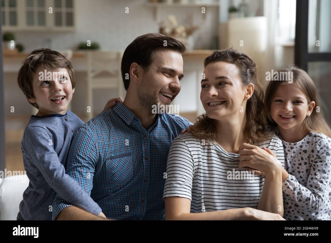 Happy family couple and two kids home portrait Stock Photo - Alamy