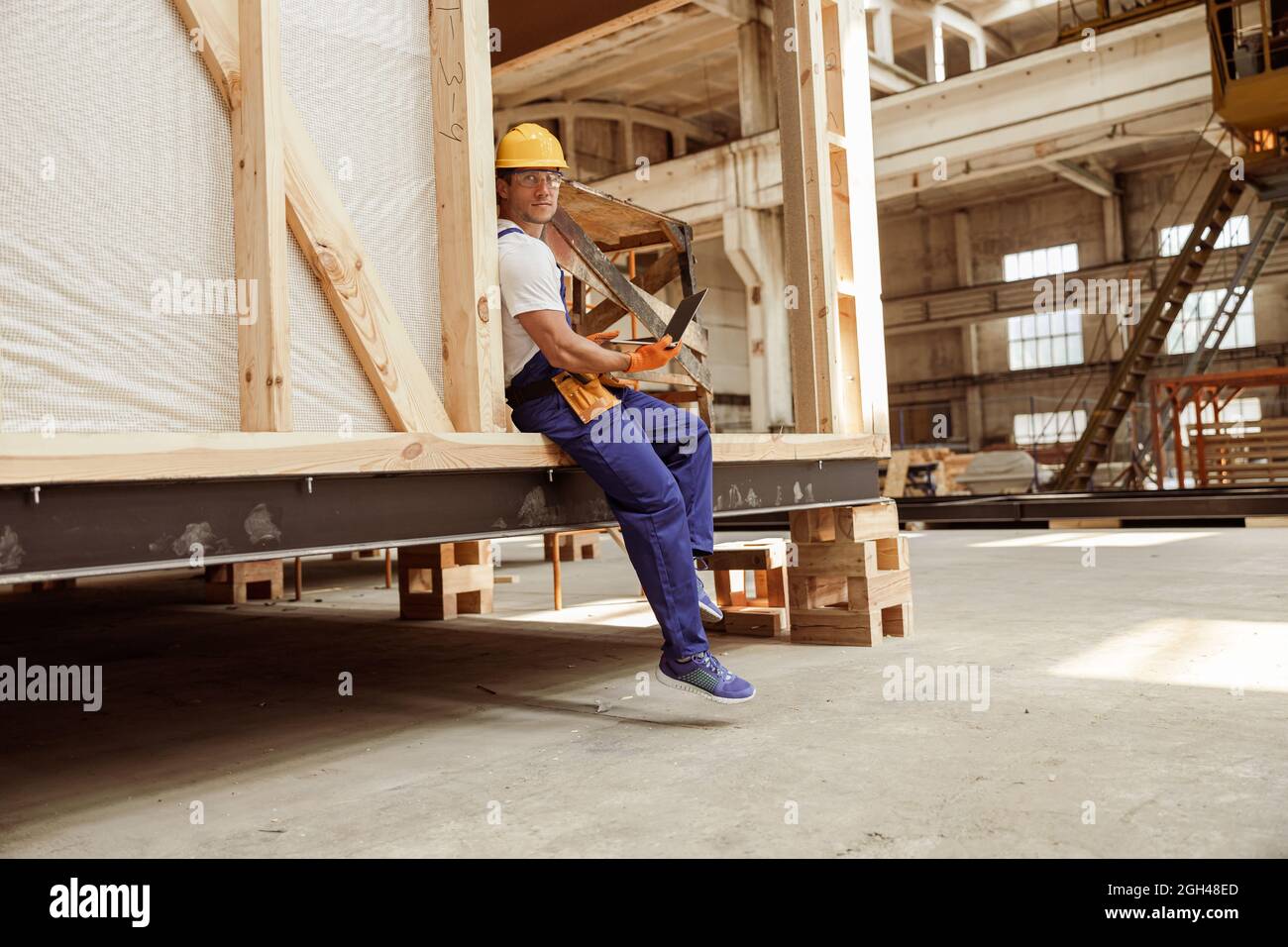 Handsome man builder using modern laptop at work Stock Photo