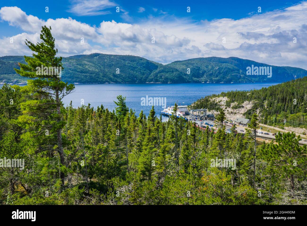 View on the Saguenay Fjord and Baie Sainte Catherine ferry boat from the top of Anse a l'Eau hill, in Tadoussa, Quebec (Canada) Stock Photo