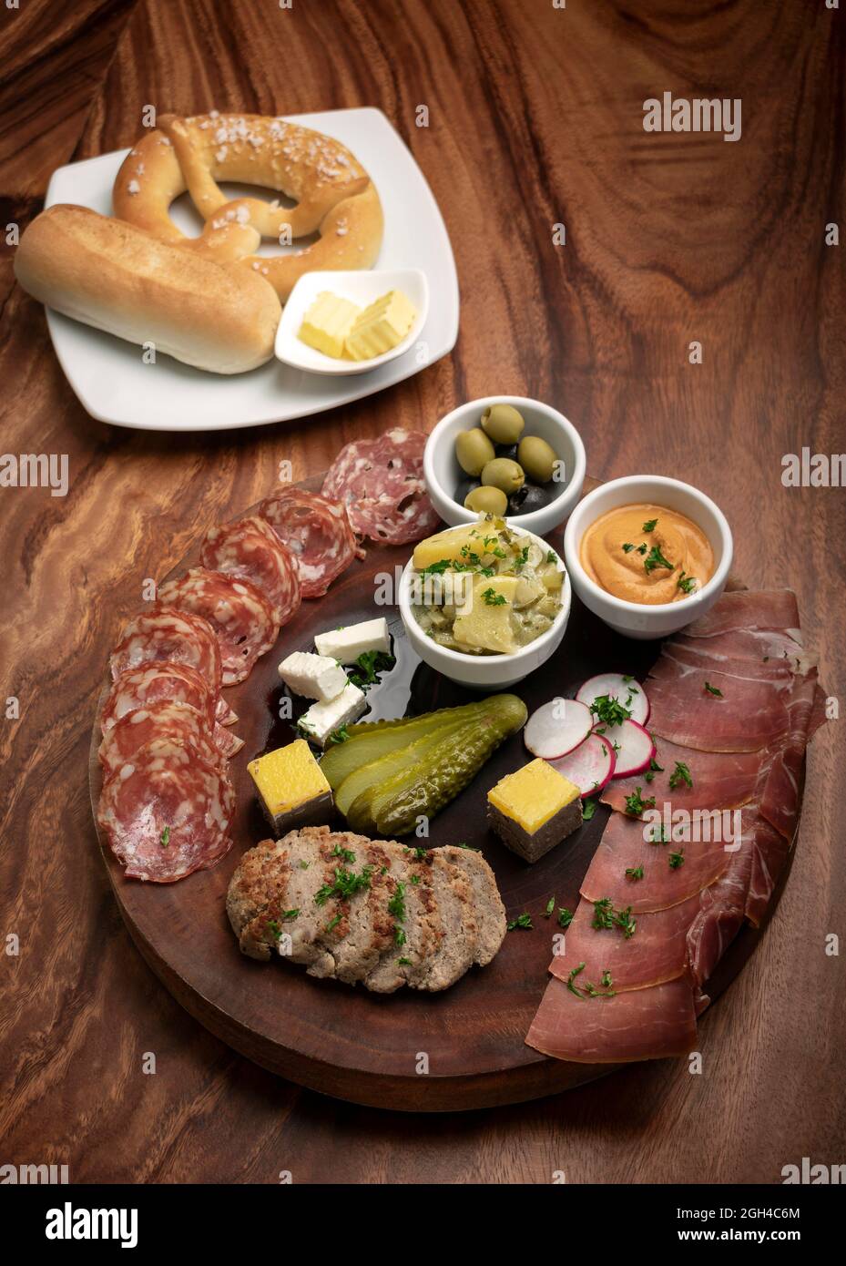 german cold cuts tapas snack platter with meats and bread on wood table background Stock Photo
