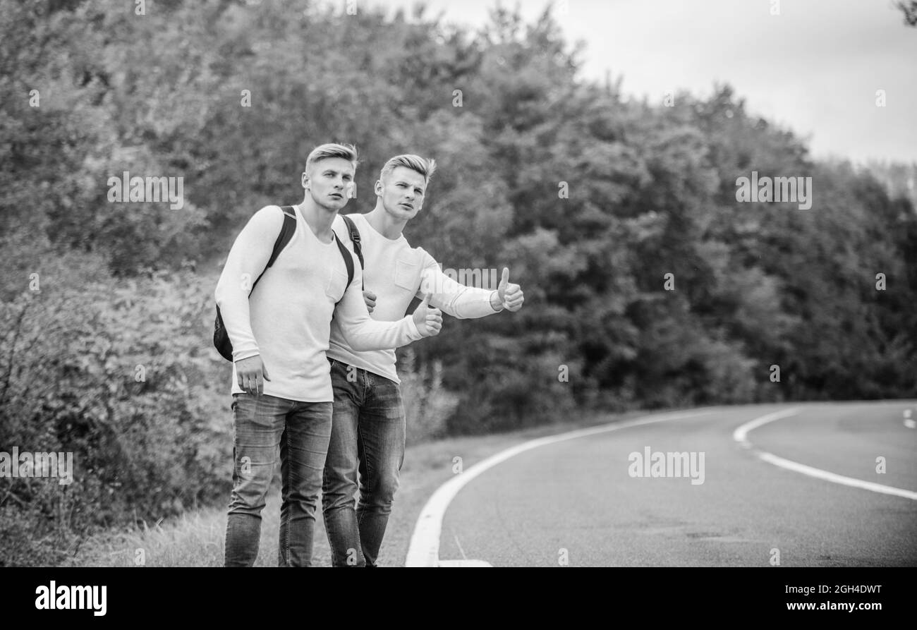 Travellers on their way. Friends hitchhikers travelling. Hitchhiking