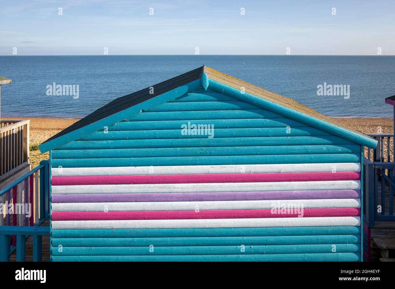 Beach huts and grasses in the sun at Tankerton in Whitstable Kent England UK Stock Photo