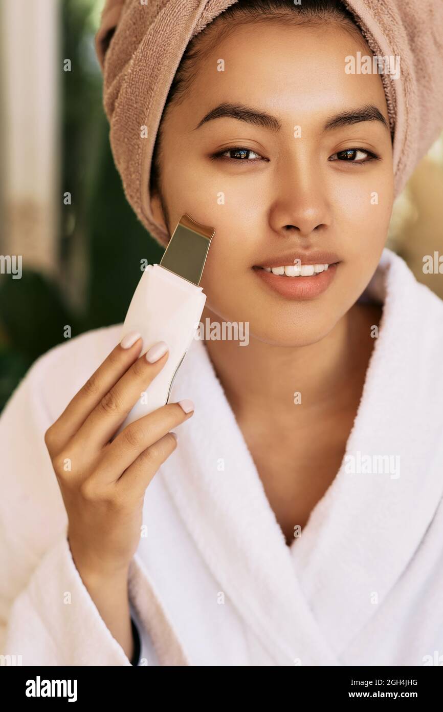 Beautiful woman's face during ultrasonic peel skin procedure. Cleansing facial skin, remove face blackheads Stock Photo