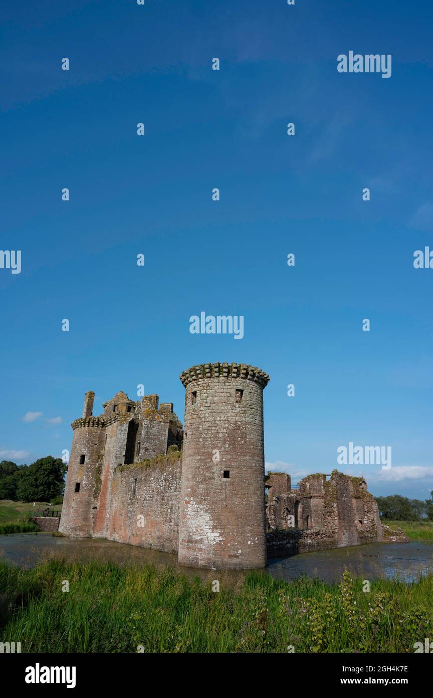 Vertical orientation of Caerlaverock Castle, Dumfries and Galloway, Scotland, in sunshine with blue sky, no people. Lots of copy space above in sky. Stock Photo