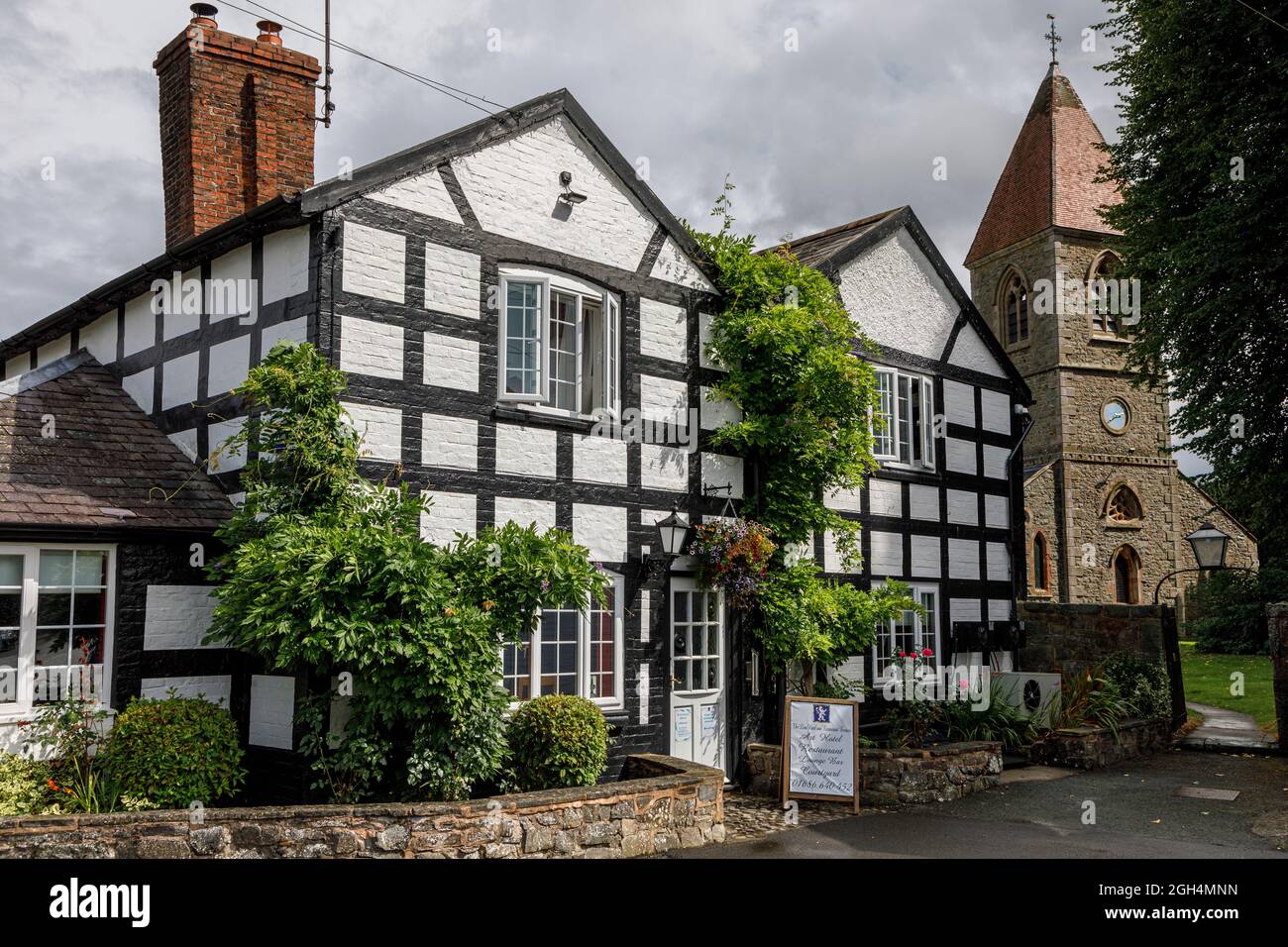 The Lion Hotel (17th century) and St Beuno's Church (19th century), Berriew, Powys, Wales Stock Photo