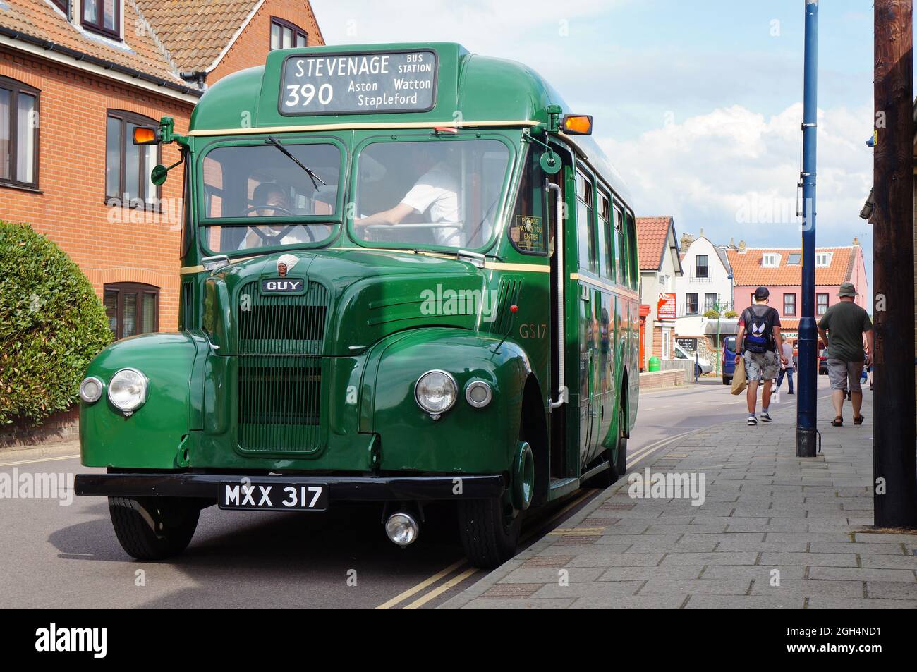 Old green London bus waiting near the rail station in Sheringham Stock Photo