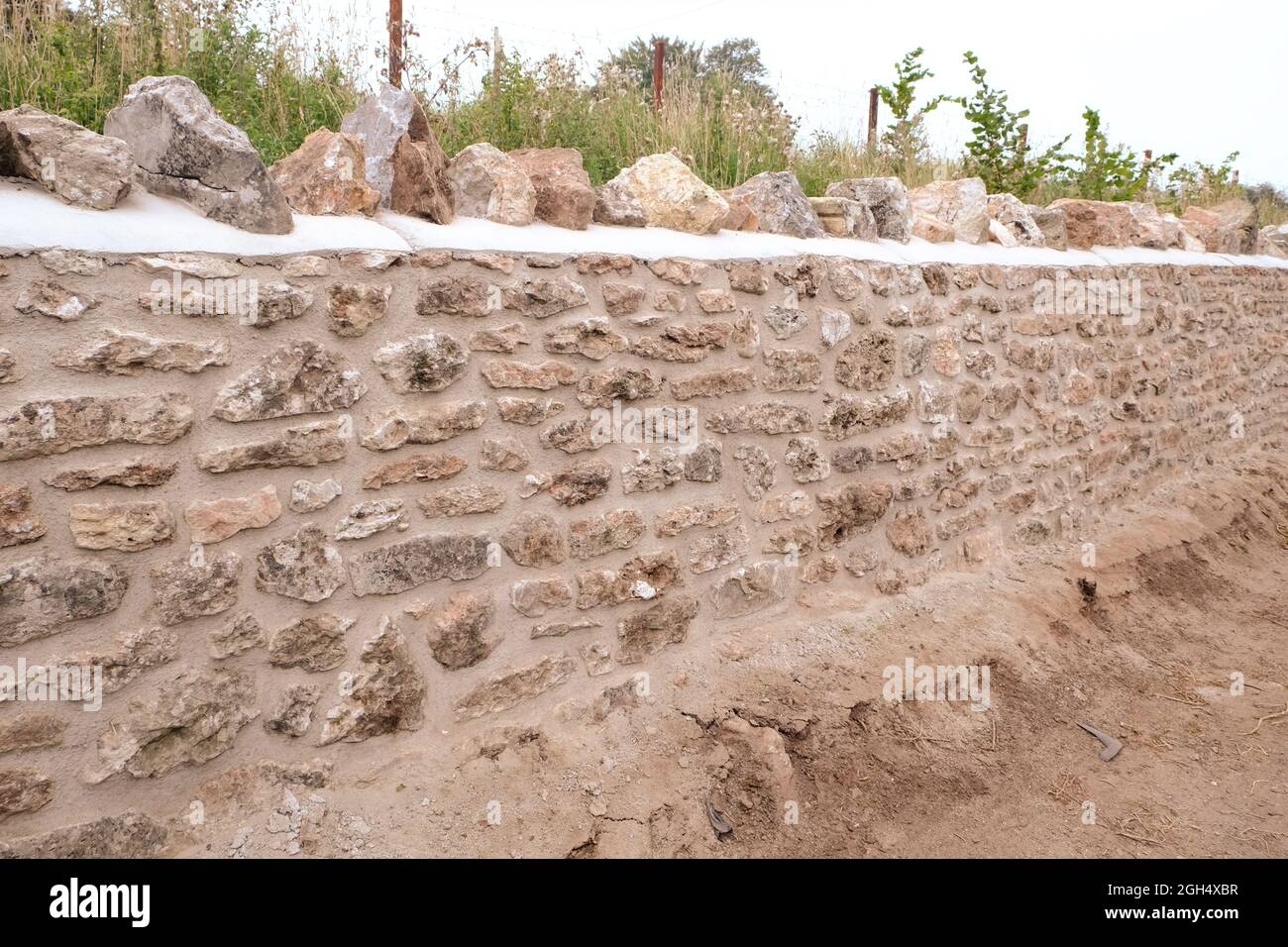 September 2021 - New stone wall being built in a traditional style Stock Photo