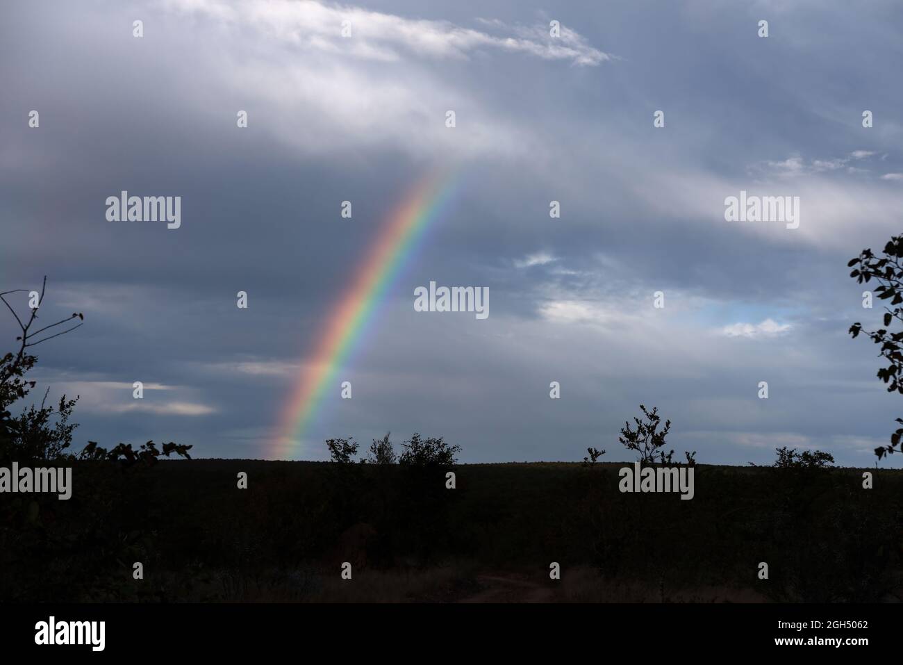 A beautiful rainbow in a partly cloudy sky Stock Photo