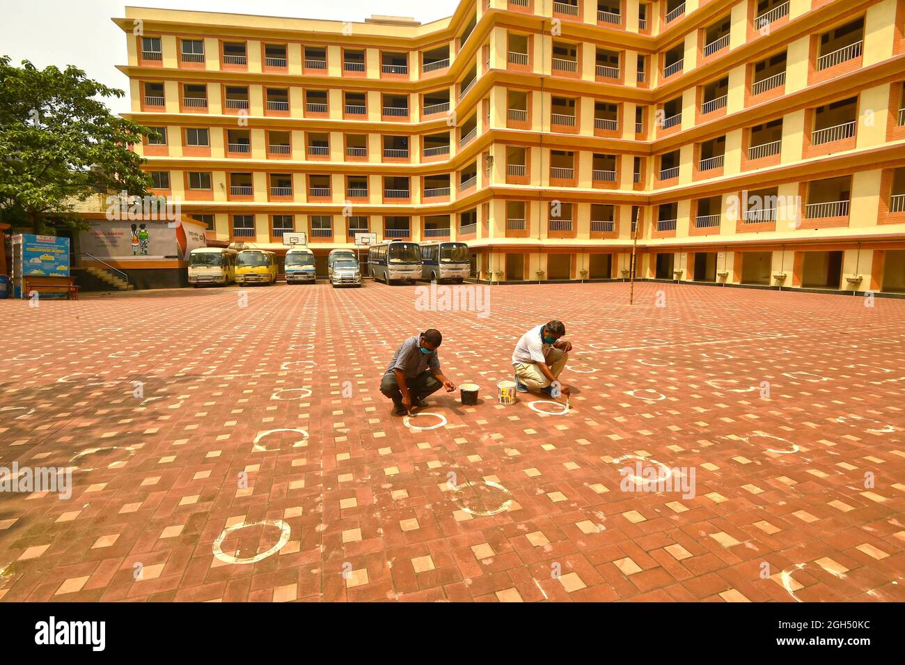 Dhaka. 5th Sep, 2021. Staff members paint circles following social distancing norms ahead of reopening of school in Dhaka, Bangladesh, on Sept. 5, 2021. The Bangladeshi government has announced the reopening of schools and colleges in the country from Sept. 12 after a closure of around 18 months. Credit: Xinhua/Alamy Live News Stock Photo