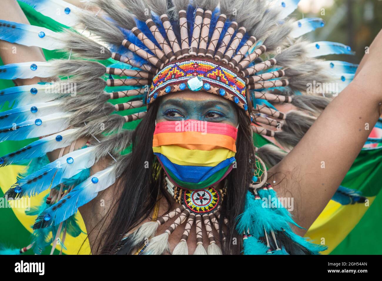 Barcelona, Catalonia, Spain. 4th Sep, 2021. Dancer dressed as an indigenous woman is seen wearing a protective mask with the LGTBI   colors and a Brazilian flag.The Pride of Barcelona 2021, has been held on a rescheduled date that Saturday, September 4, under the theme ''together against the stigma of HIV'', with a reading of a manifesto and as a great attraction a Brazilian samba school parade. (Credit Image: © Thiago Prudencio/DAX via ZUMA Press Wire) Stock Photo