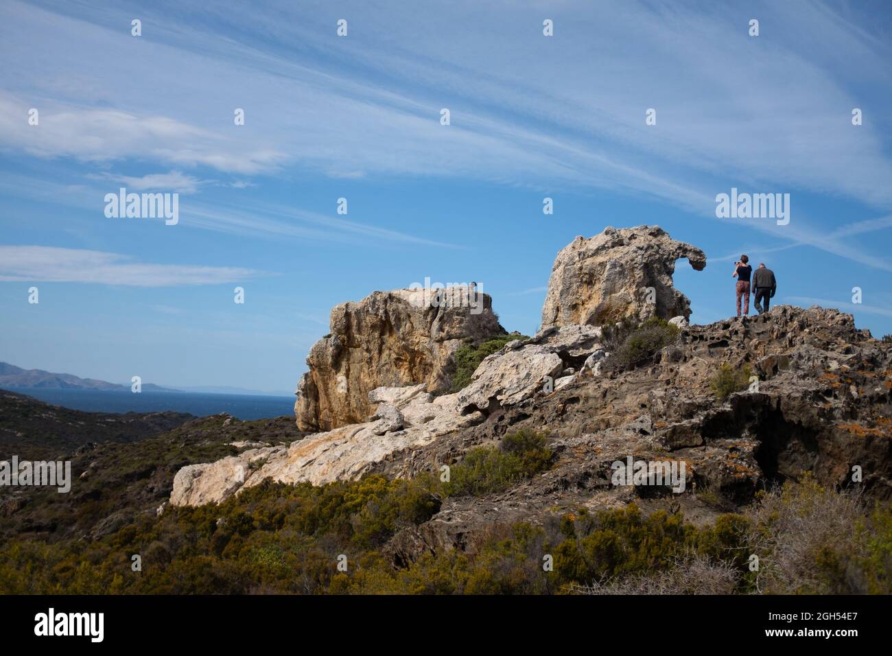 People walk on rock formations at the Cap de Creus, Cadaqués, Costa Brava, Catalonia, Spain Stock Photo