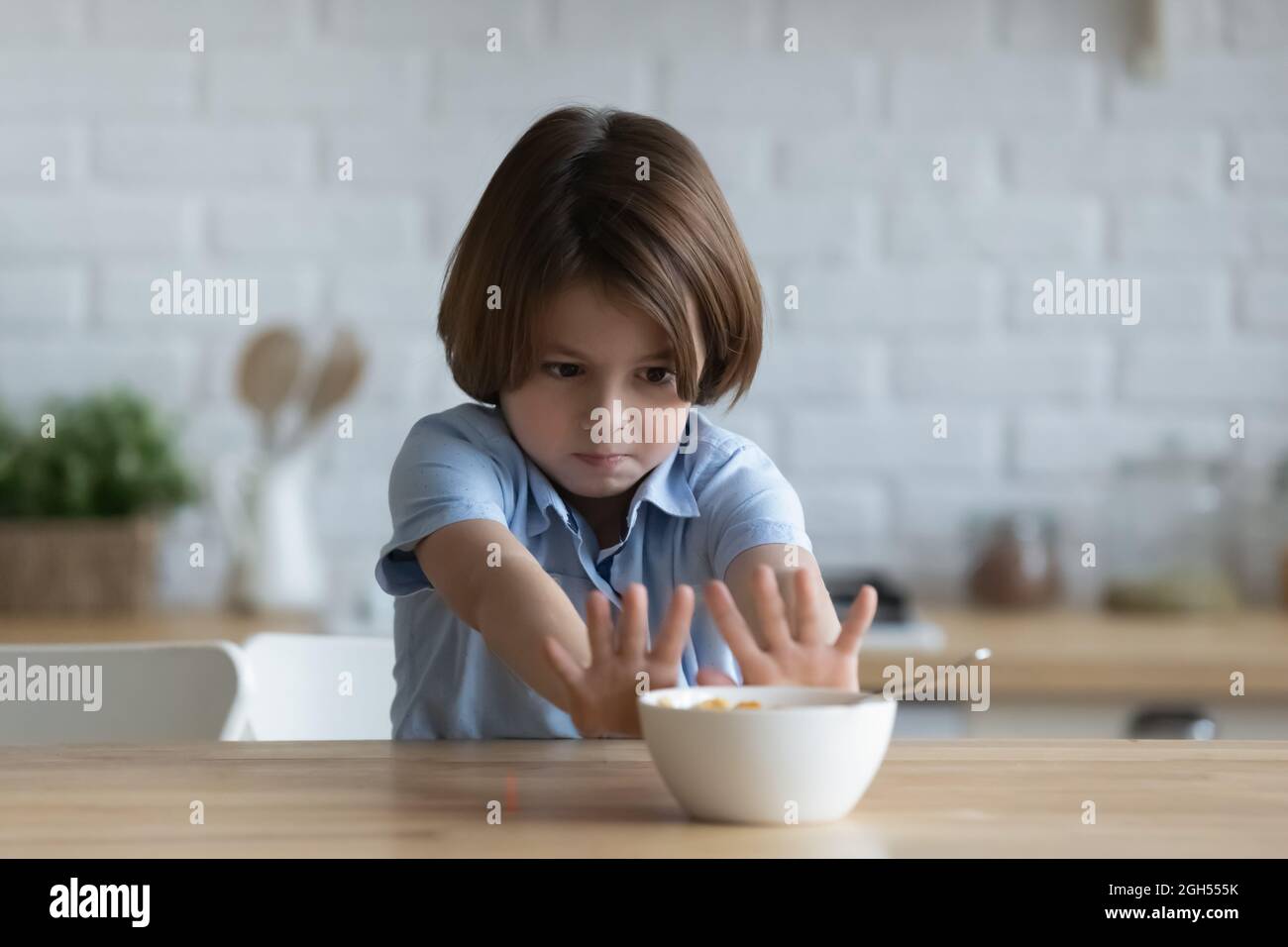 Stubborn little kid boy rejecting eating dry breakfast. Stock Photo