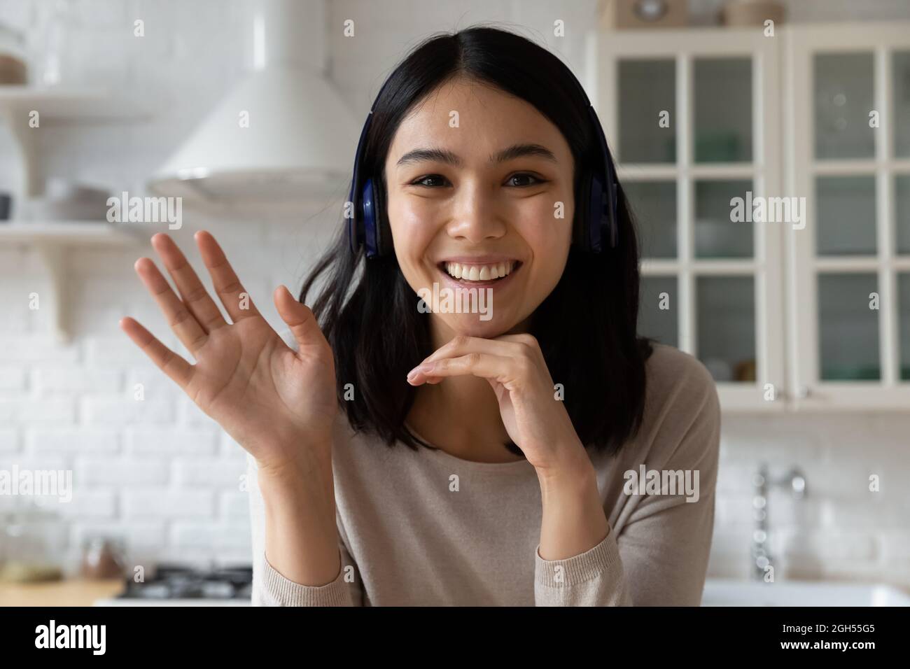 Happy millennial woman in headphones holding video call meeting Stock ...