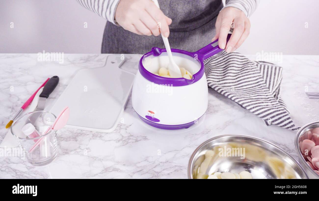 Step by step. Melting chocolate candy melts in an electric candy melting pot  Stock Photo - Alamy