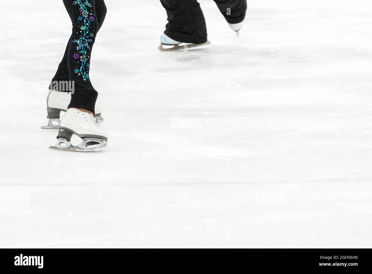 View of a figure skater and her coach feet at the figure skating