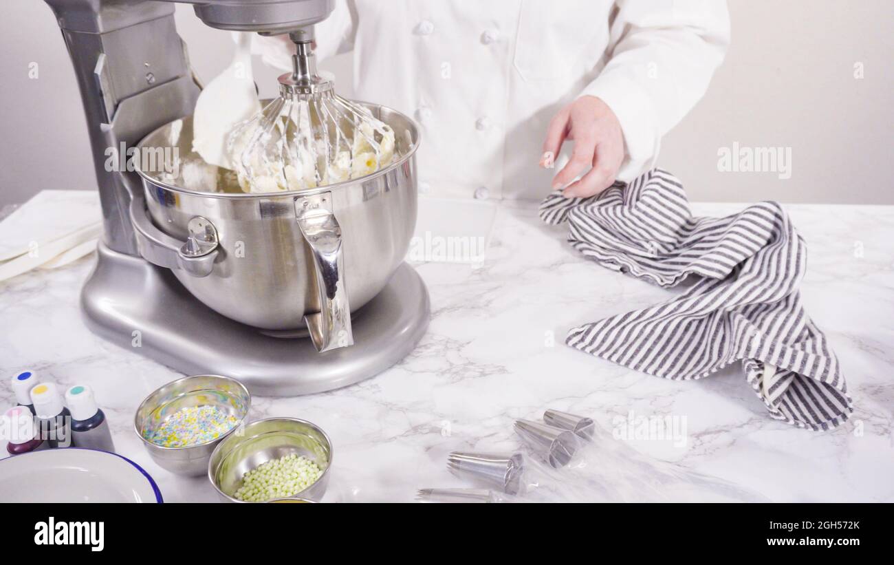 Preparing Italian buttercream frosting in standing kitchen mixer Stock