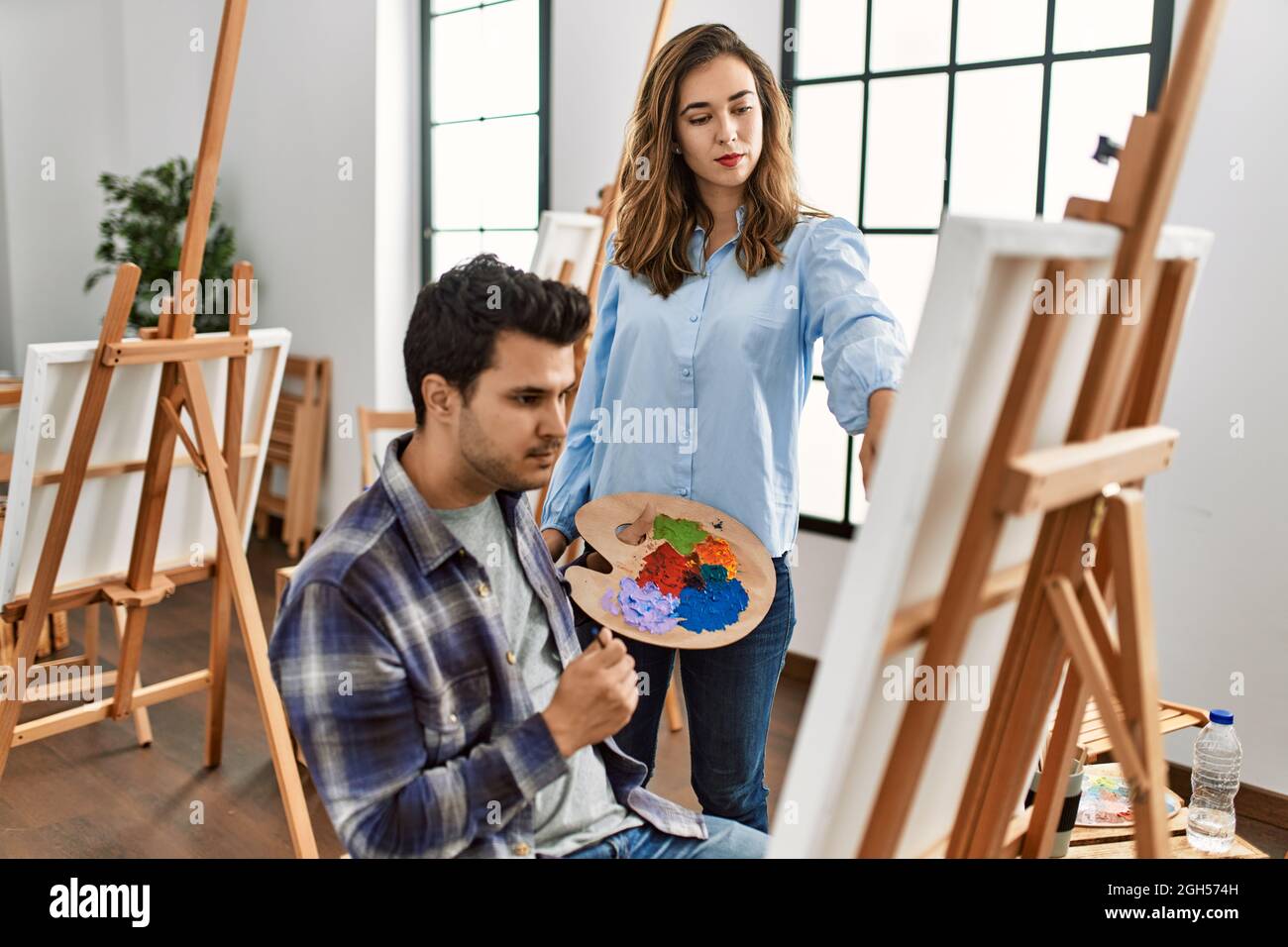Paint teacher teaching to student at art school Stock Photo Alamy