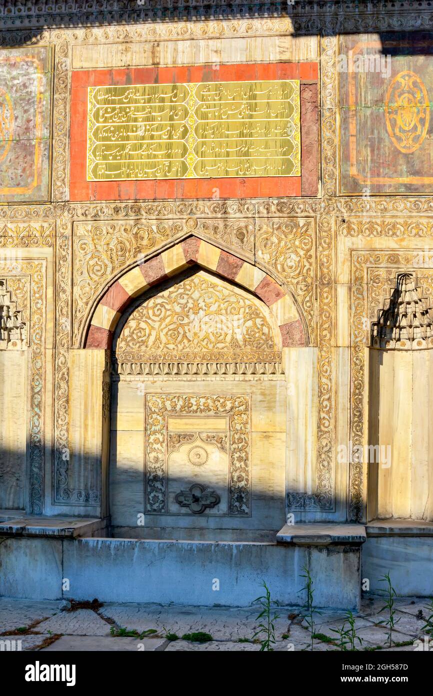 Ol and historic muslim portal with washbasin and arabesques in Istanbul, Turkey Stock Photo