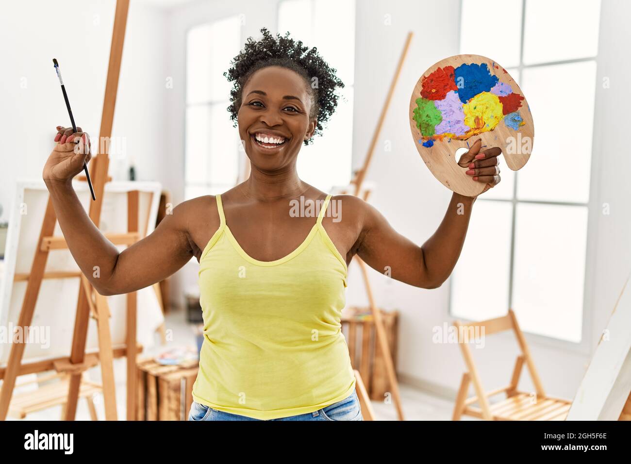 Young african american artist woman smiling happy drawing at art studio ...