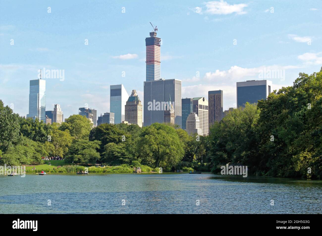 NEW YORK, USA - August 5, 2014: Pond in the central park in NYC. Central Park and Manhattan Skyline. Midtown Manhattan skyline viewed from Central Par Stock Photo
