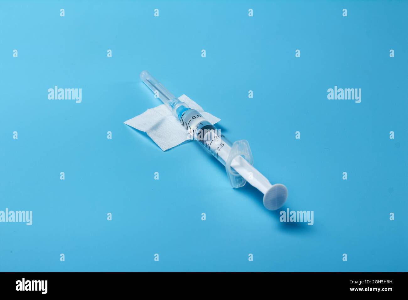 The vaccine is typed in a syringe with the vaccine on a blue background ...