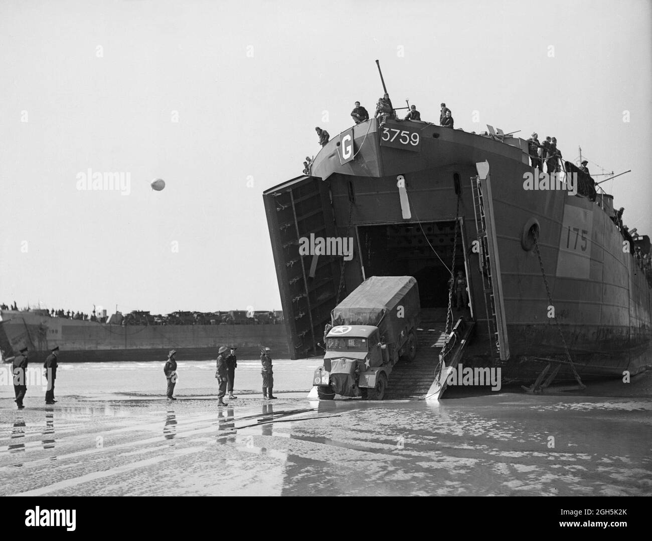 A truck drives out of a landing craft onto the beaches of Normandy on D-Day, 6th June 1944 Stock Photo