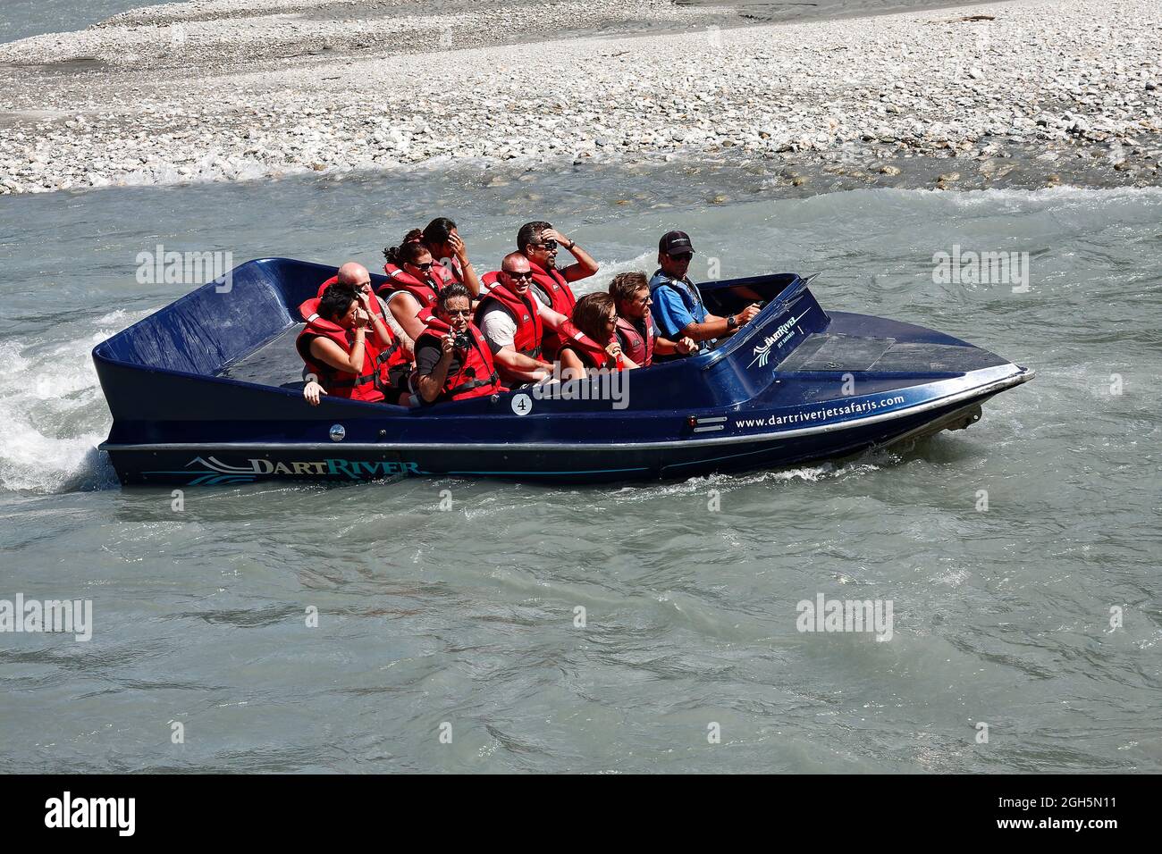 Dart River cruise jet boat moving, water; people, wear PFDs, life