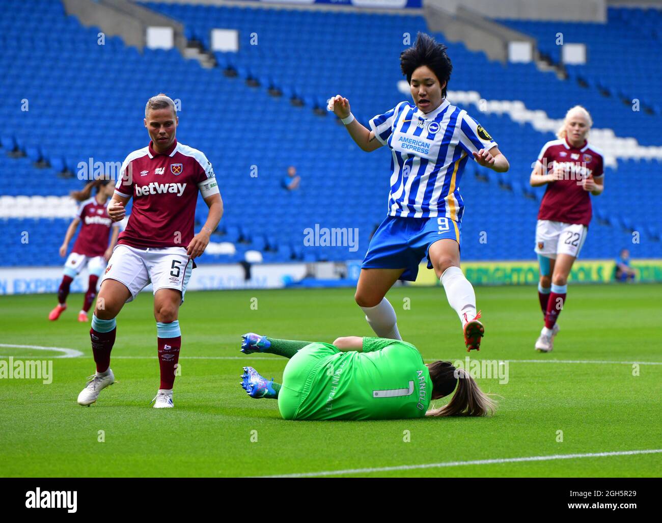Brighton, UK. 05th Sep, 2021. Lee Geum-Min of Brighton and Hove Albion jumps over Mackenzie Arnold Goalkeeper of West Ham United during the FA Women's Super League match between Brighton & Hove Albion Women and West Ham United Ladies at The Amex Stadium on September 5th 2021 in Brighton, United Kingdom. (Photo by Jeff Mood/phcimages.com) Credit: PHC Images/Alamy Live News Stock Photo