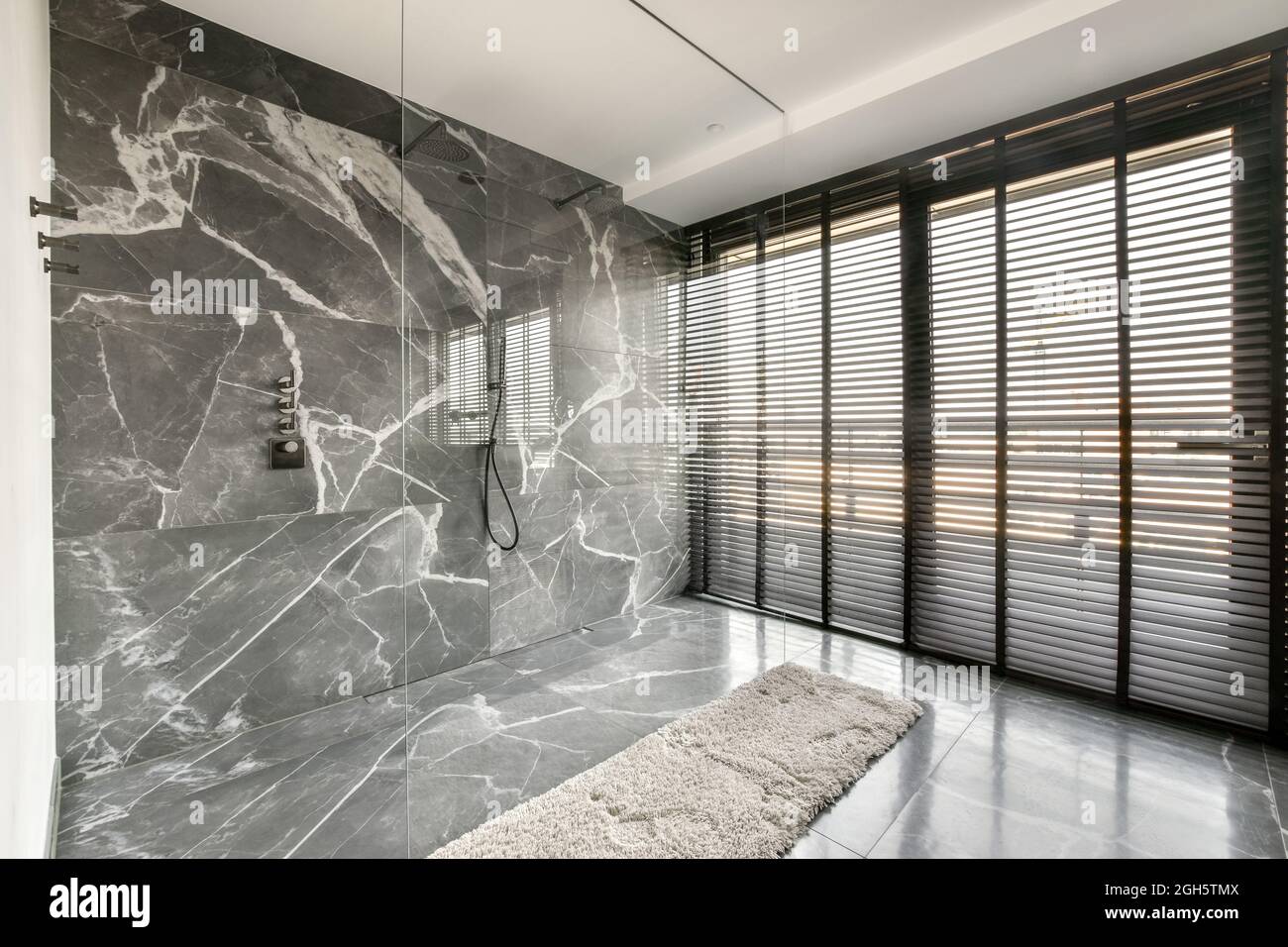 Interior of contemporary spacious bathroom with shower unit on tiled ... - Luxury Apartments With Marble Partitions