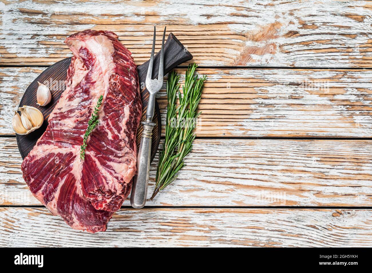 Butchers choice steak Onglet Hanging Tender beef meat on a cutting board. White wooden background. Top View. Copy space Stock Photo