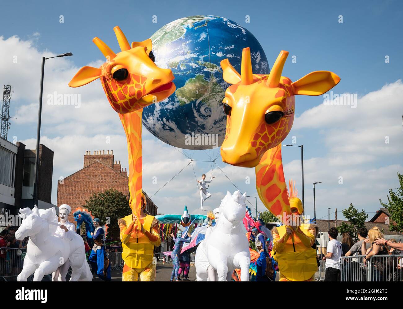 Costumed performers, giant puppets and inflatables during the the Earth