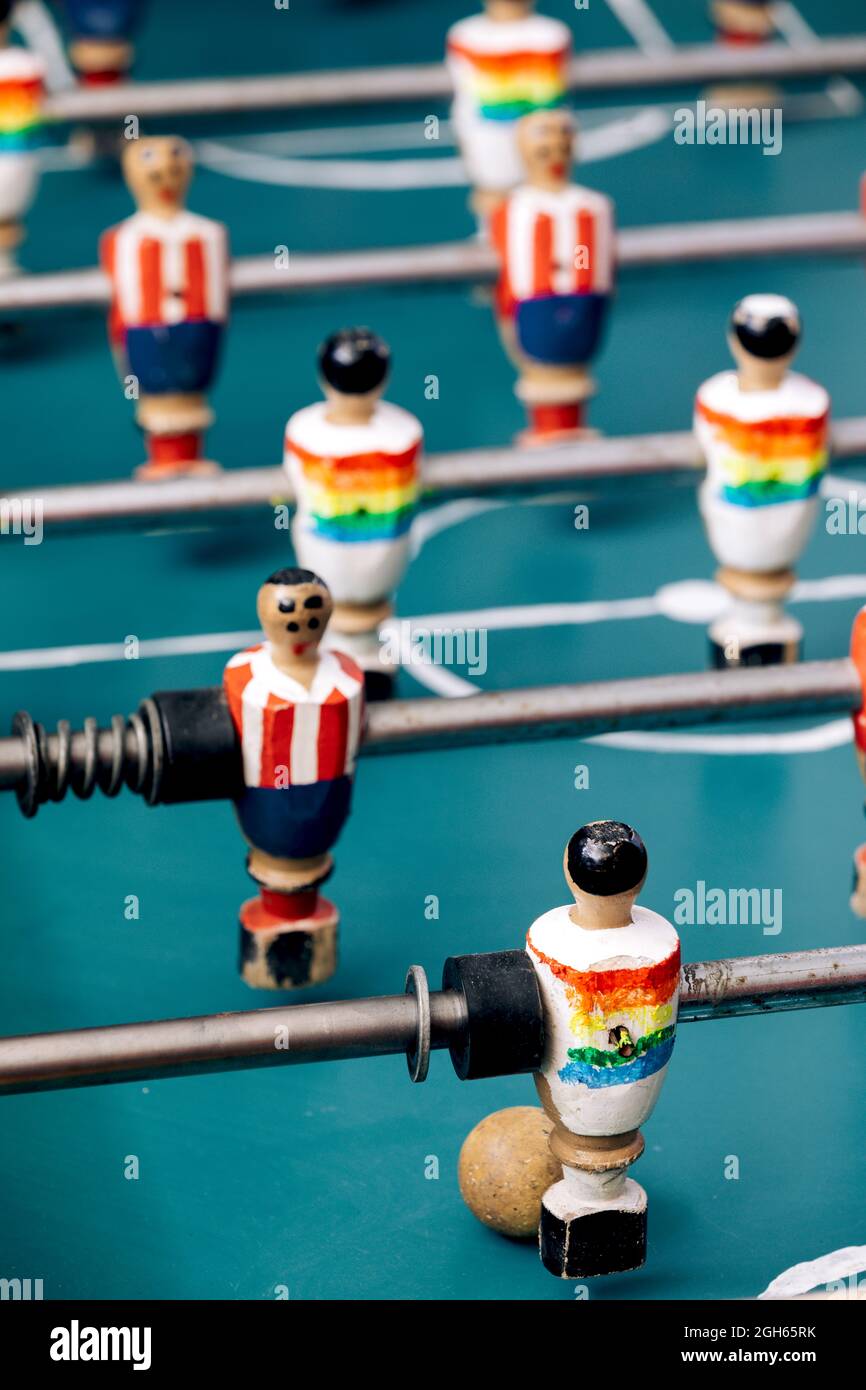 High angle of detail of retro table soccer with wooden miniature figurines of players on metal bars Stock Photo