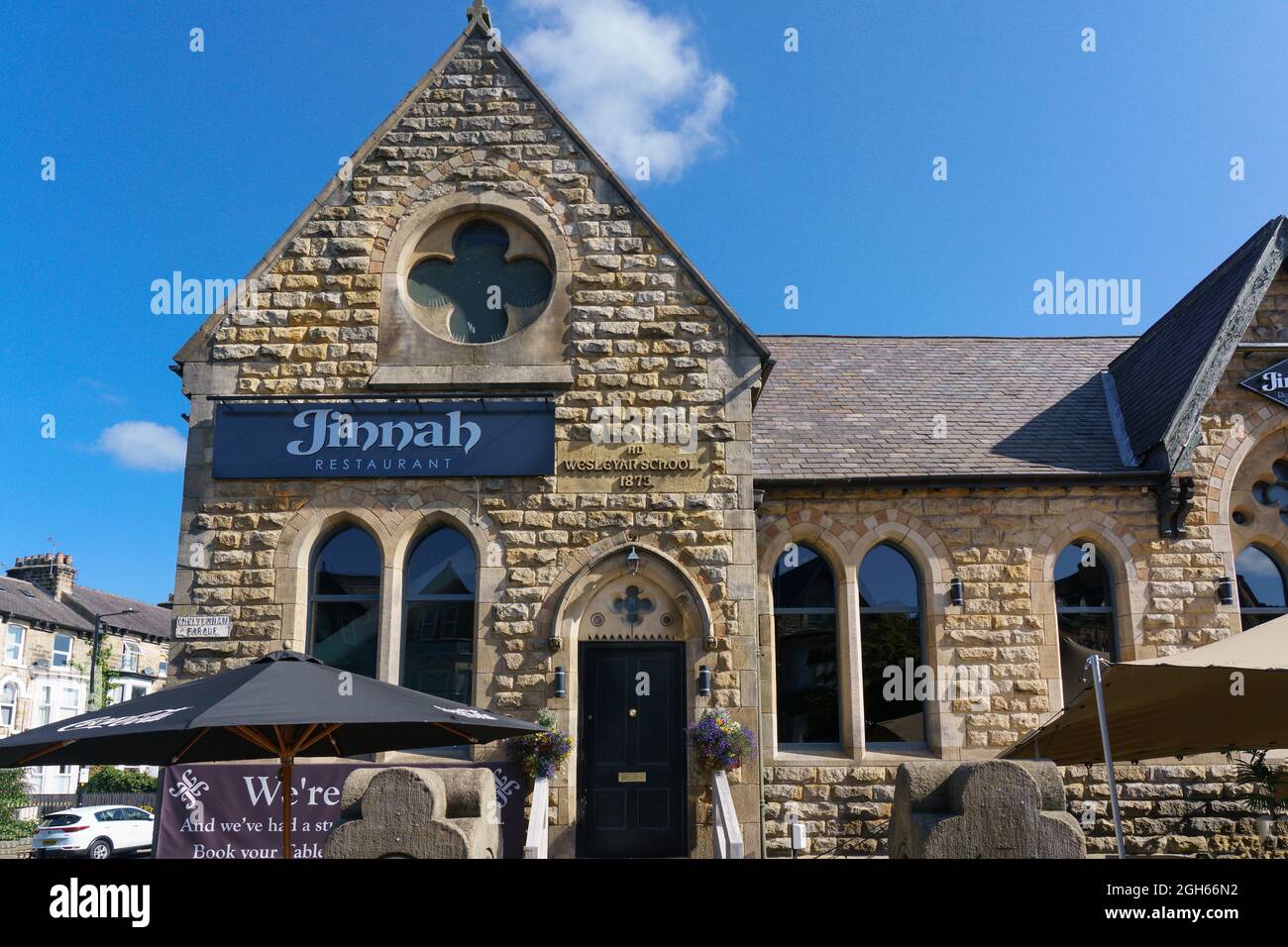 Jinnah Indian Restaurant entrance with stone, brick walls, and vaulted windows, Harrogate, North Yorkshire, Britain, UK. Stock Photo