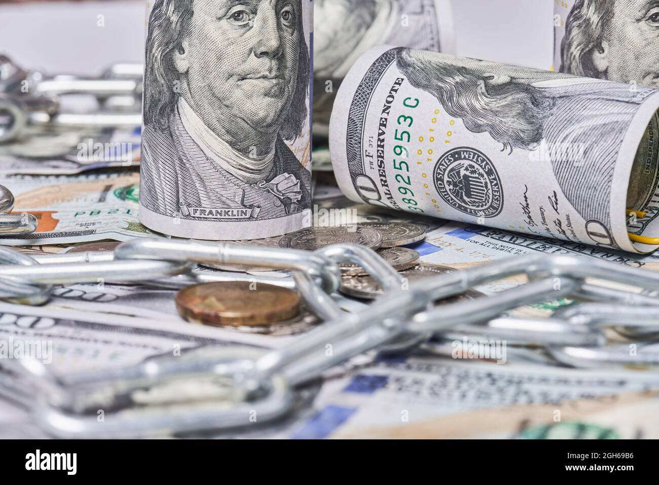 Pile of money, chain and bitcoin. Bitcoin and one hundred dollar banknotes  with chain. Cryptocurrency in cyberspace as a system of payment. Crime  Stock Photo - Alamy